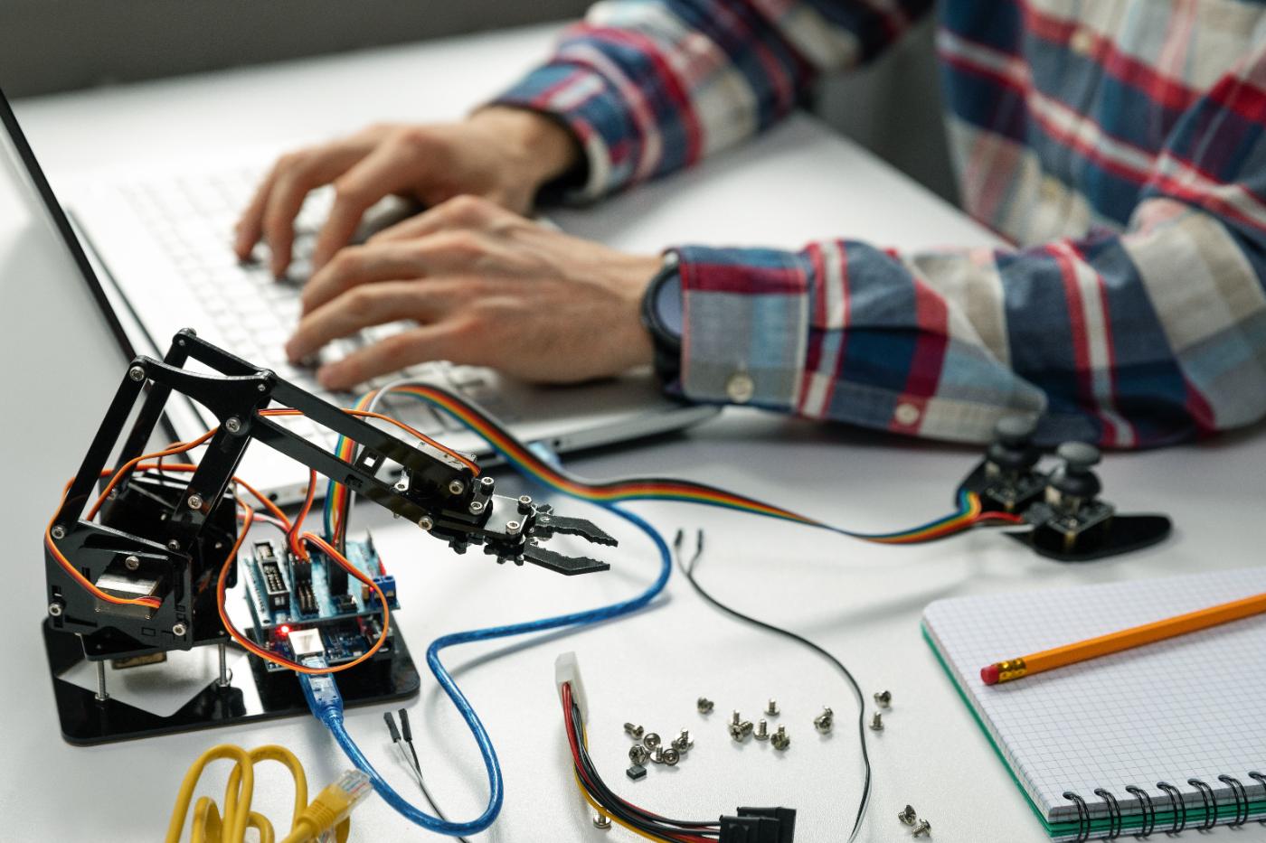 An instructor programming a desktop robot arm